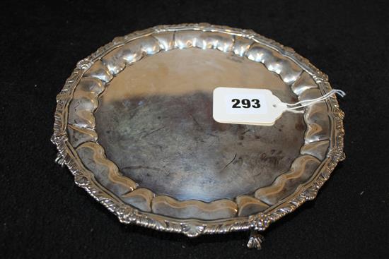 Circular silver waiter with lobed acanthus border, on four paw feet